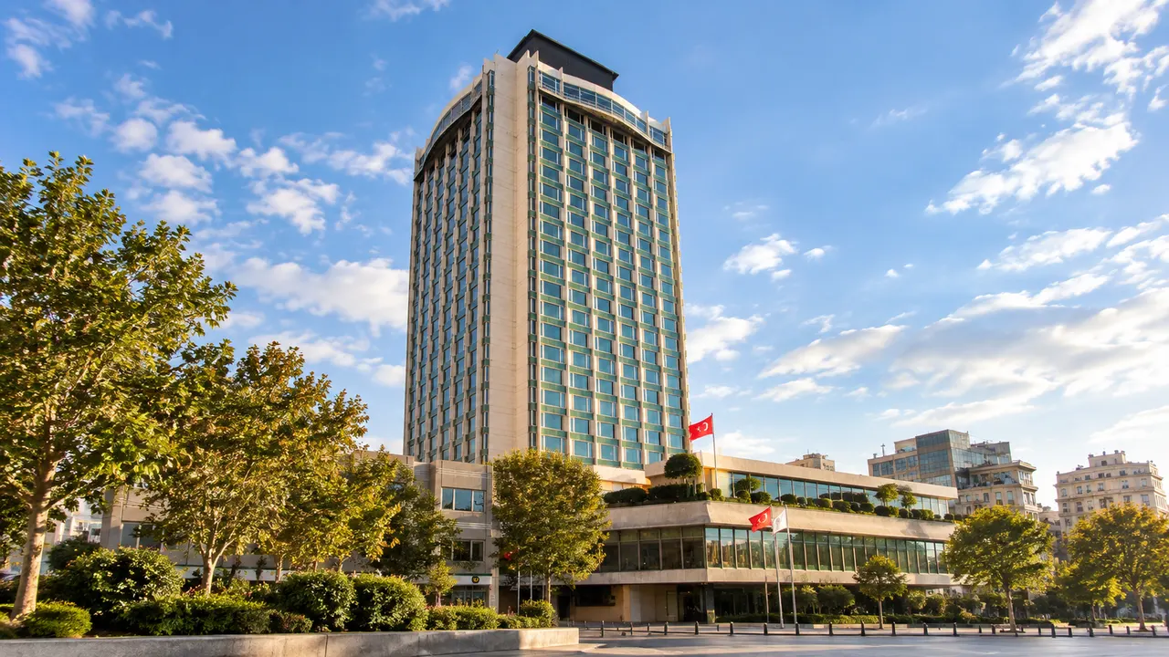 The Marmara Taksim tower with a stone facade grid and blue-green windows in a daylight city view